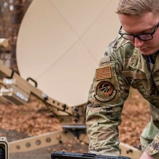 US Air Force Cyber personnel setting up a satellite in the field.