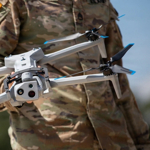 A soldier holding a drone