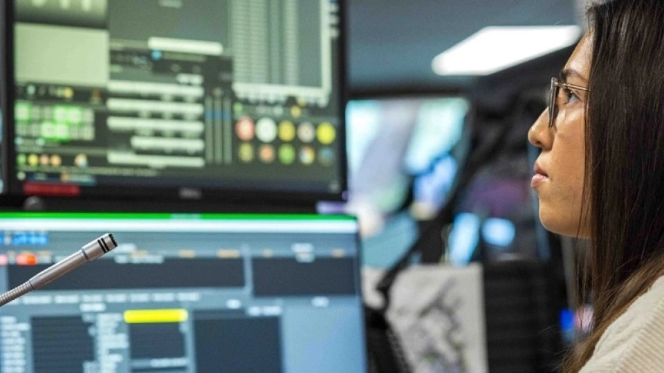 An operator watches dashboards in a security operations center.