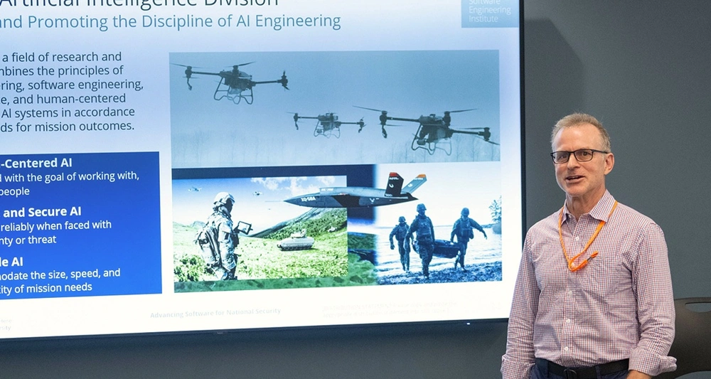 SEI employee presenting a slide detailing the Artificial Intelligence Division.