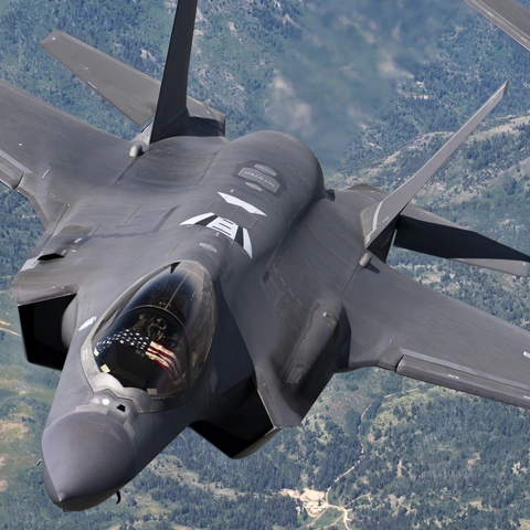 Two fighter jets flying in formation.