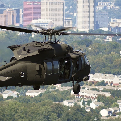Military helicopter in flight above the city of Pittsburgh.