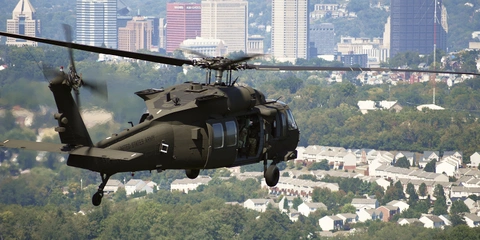 Military helicopter in flight above the city of Pittsburgh.