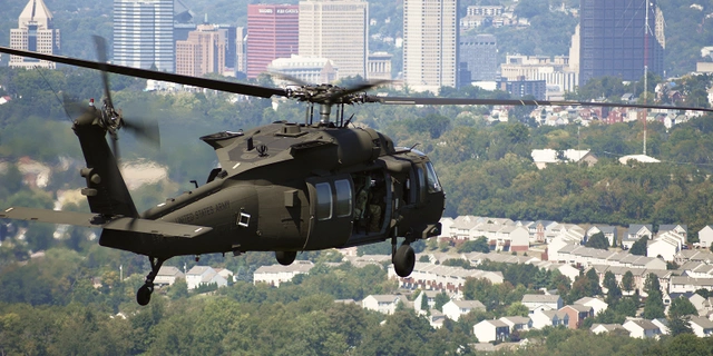Military helicopter in flight above the city of Pittsburgh.