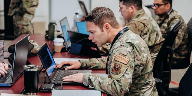 Military personnel participating in a cybersecurity training exercise.