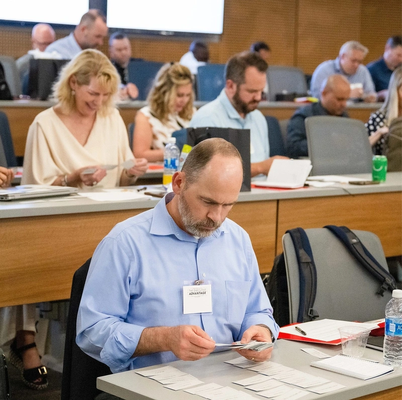 A room full of professionals participating in a training seminar.