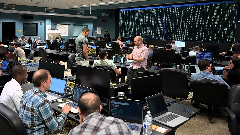 Service members work on computers in an emergency operations center.