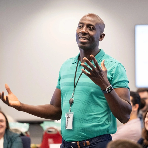 A member of SEI staff speaking at an onboarding event for new employees.