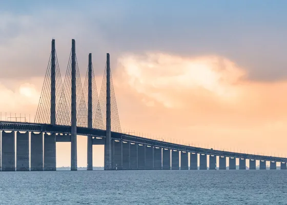 bright sky behind a bridge over open water