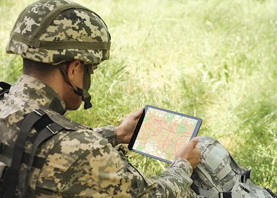 Soldier reading a map on a tablet