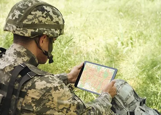 Soldier reading a map on a tablet