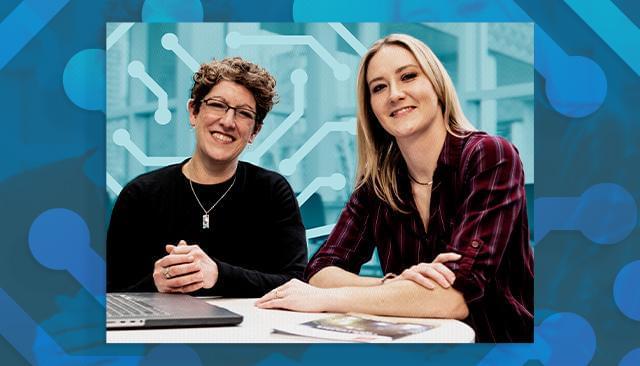 Carol Smith and Alex Van Deusen sitting at a desk.