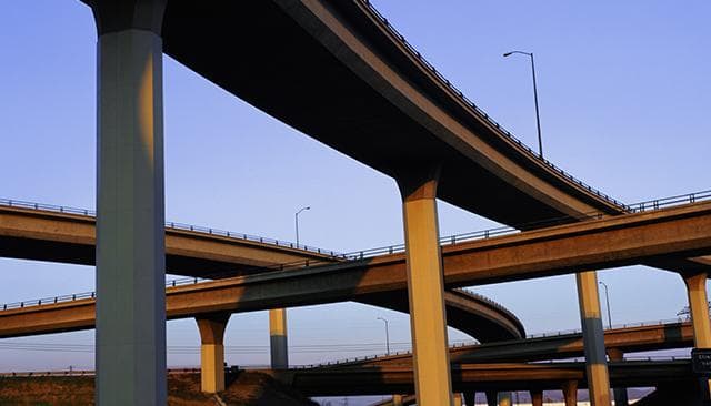 Highway overpasses shot from below.