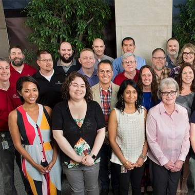 A group of smiling SEI employees.